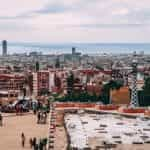 A crowd of people gathers in a plaza in Barcelona, Spain.