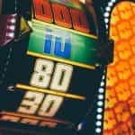 A brightly-lit roulette wheel in a casino.