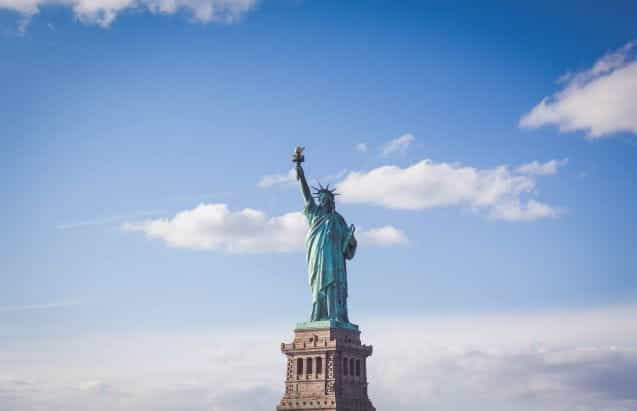 The Statue of Liberty against a blue sky backdrop.