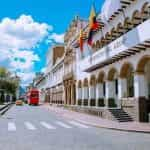 A building in Cuenca, Ecuador, brandishes two flags.