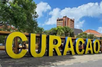 A large yellow sign spells out the name Cura?ao in the city of Willemstad, Cura?ao.