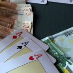 Three Aces sat along cash Euro notes.